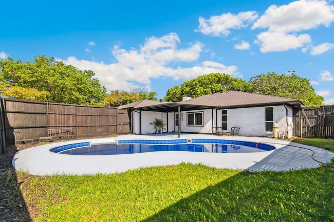 View of pool with a lawn, a fenced backyard, a patio, and a fenced in pool | Image 37