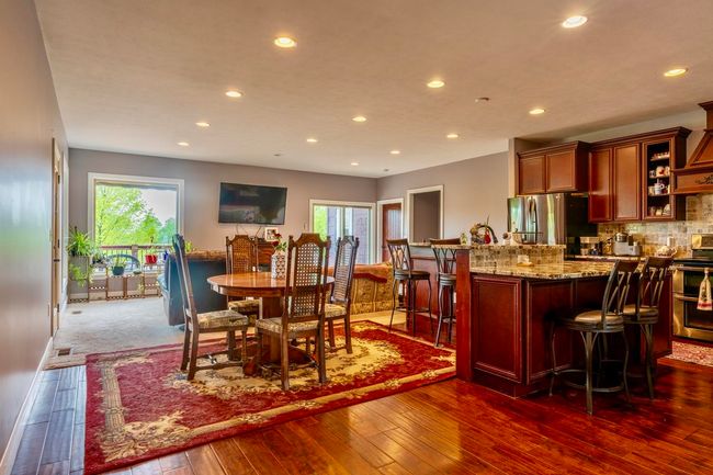 Dining room featuring dark wood finished floors, baseboards, and recessed lighting | Image 6