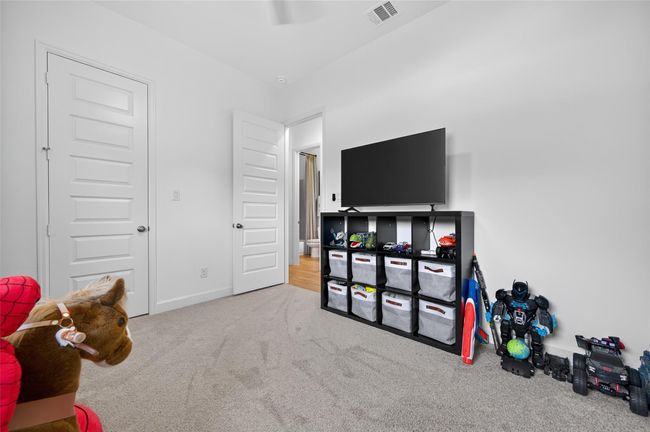 This secondary bedroom includes a large closet and direct access to the hall bath. Clean finishes and ample floor space make it ideal for a bedroom, playroom, or home office. | Image 19