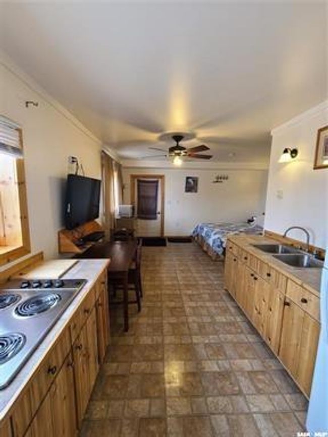Kitchen featuring ceiling fan, sink, gas stovetop, and crown molding | Image 20