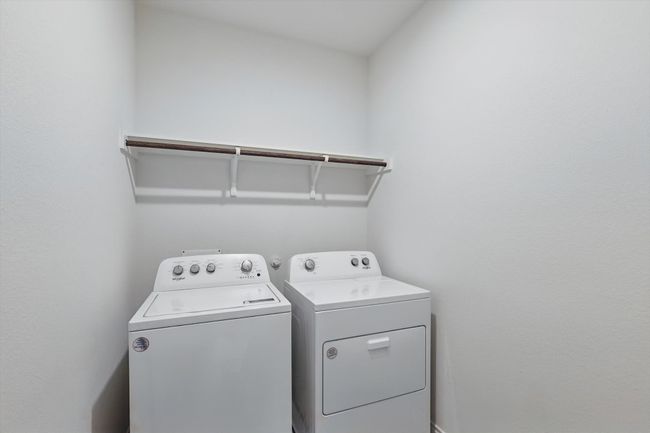 Laundry room with washing machine and clothes dryer | Image 19