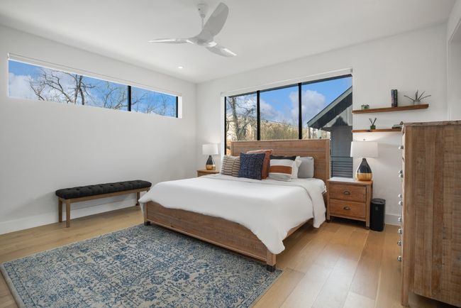 Primary bedroom on the second floor with light wood-style flooring, baseboards, and a ceiling fan | Image 17