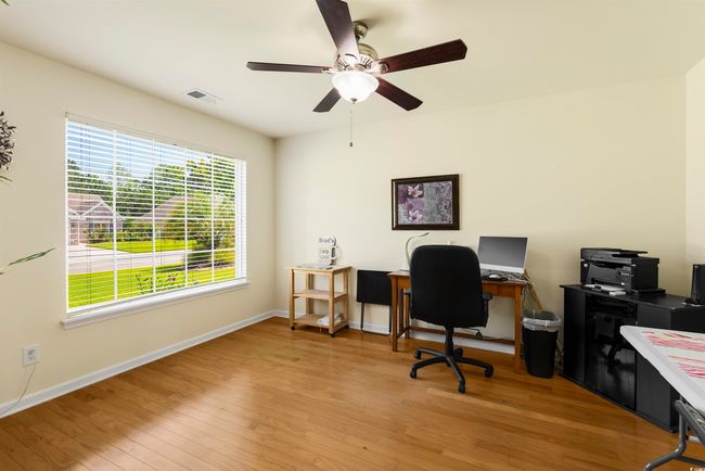 Home office featuring ceiling fan, light wood-style flooring, and baseboards | Image 16