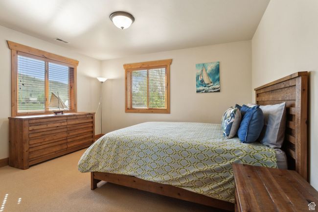 Bedroom with multiple windows and carpet flooring | Image 38