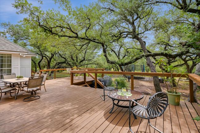 Overlooking the expansive yard, the deck extends the home’s living space into the outdoors. | Image 25
