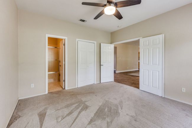 Unfurnished bedroom featuring carpet, visible vents, and baseboards | Image 22
