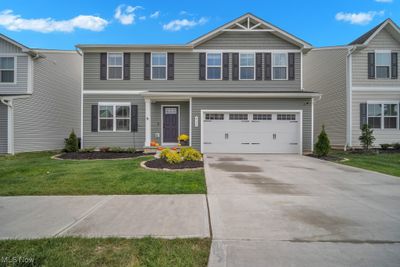 View of front of house with a front lawn and a garage | Image 1