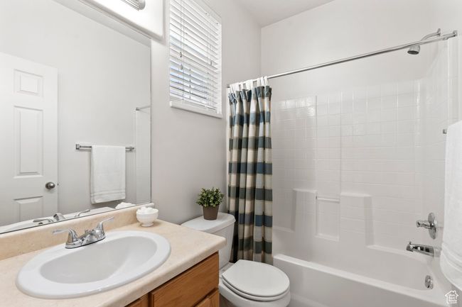 Full bath with toilet, shower / bath combo with shower curtain, and vanity | Image 12