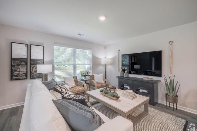 Living room featuring wood finished floors and baseboards | Image 7