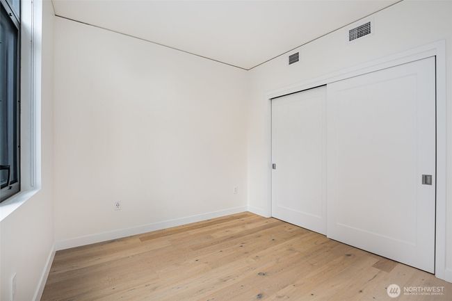 Bedroom with large closet and built-in organizers. | Image 10