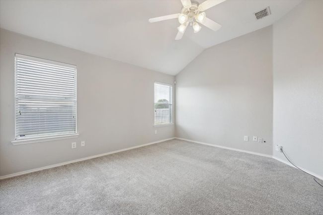 Unfurnished room featuring carpet, lofted ceiling, ceiling fan, and baseboards | Image 10