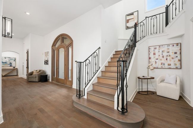 Foyer featuring wood finished floors, stairway, arched walkways, recessed lighting, and baseboards | Image 4