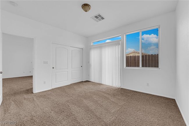 Unfurnished bedroom featuring a closet, visible vents, carpet flooring, and baseboards | Image 9