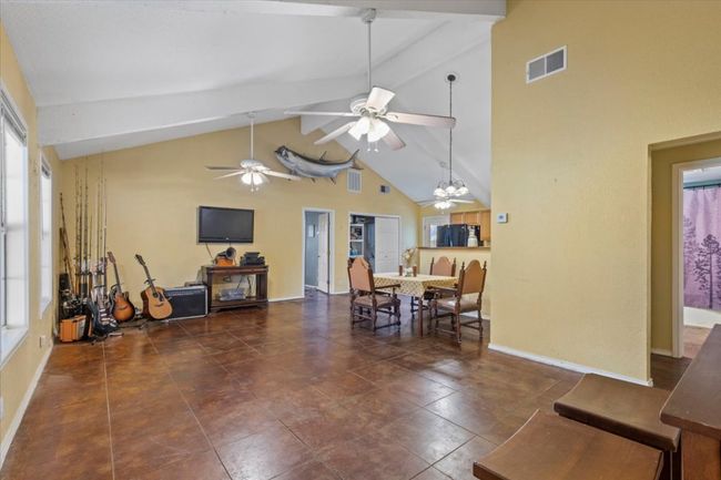 Dining area featuring a ceiling fan, high vaulted ceiling, and beamed ceiling | Image 4