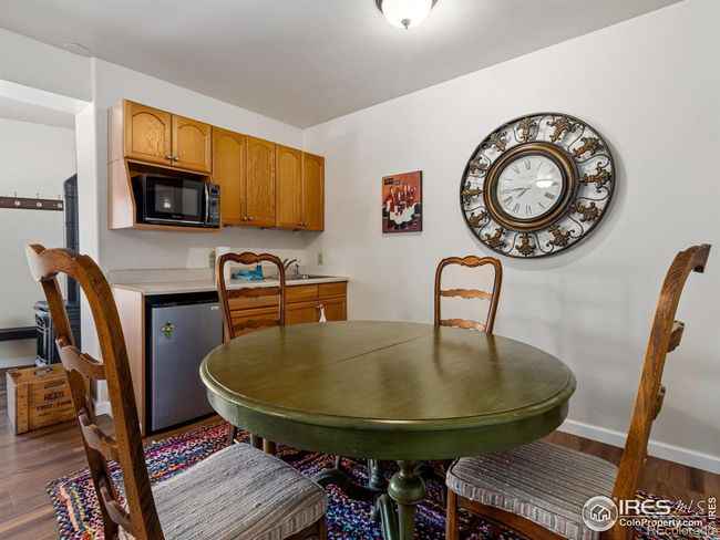 Dining room and kitchenette has microwave, mini fridge, cabinets and sink | Image 22