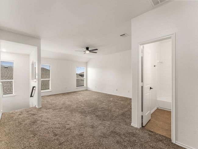 Carpeted empty room featuring a ceiling fan | Image 26