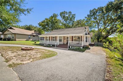 View of front of property with a porch, a front lawn, and a fire pit | Image 3