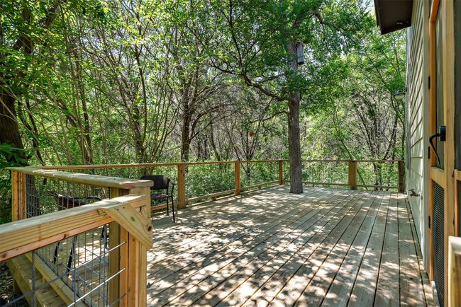 The back deck is a charming extension of the home, offering plenty of space to relax, entertain, or simply enjoy the peaceful view of the wooded greenbelt | Image 34