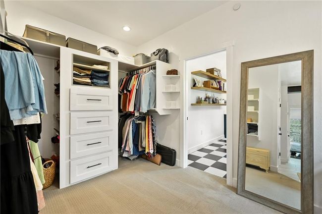 Walk in closet with light carpet and light flooring | Image 31