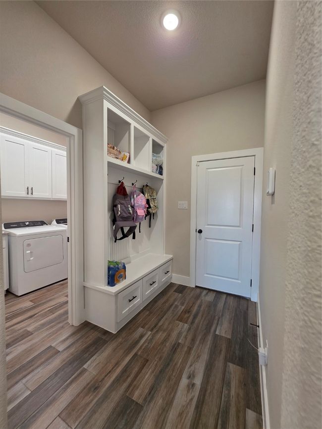 Mudroom with washer and dryer and dark wood finished floors | Image 17
