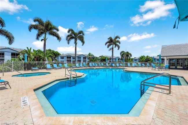 Community pool featuring a patio, a hot tub, and a residential view | Image 19