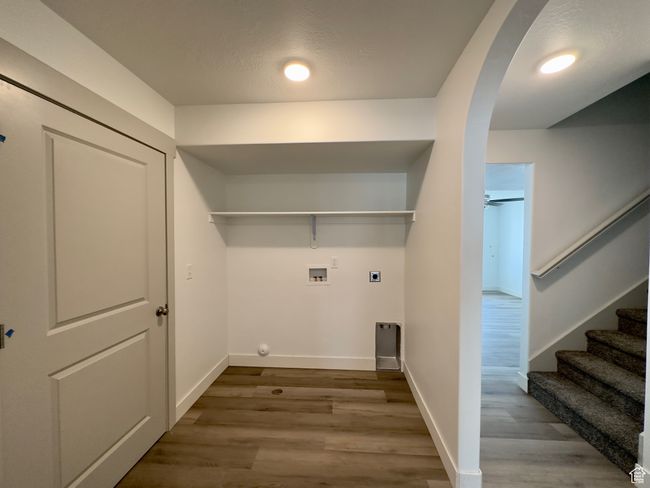 Laundry room with LVP flooring, ceiling fan, electric dryer hookup, and washer hookup | Image 6