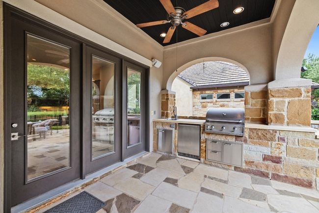 View of patio featuring a sink, ceiling fan, and french doors | Image 29
