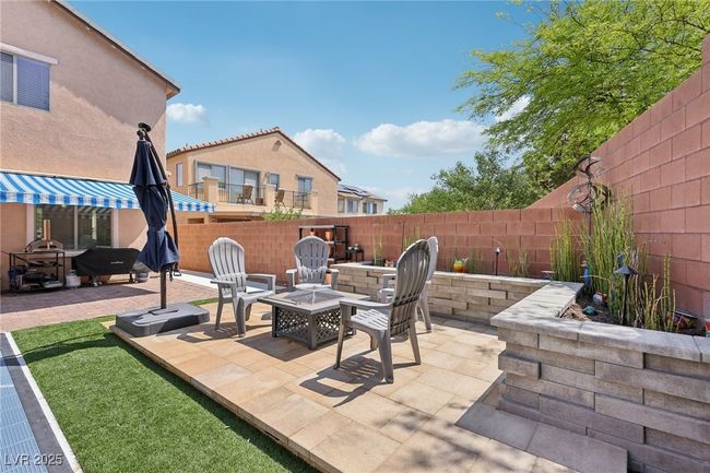Fenced backyard with an outdoor fire pit and a patio area | Image 65