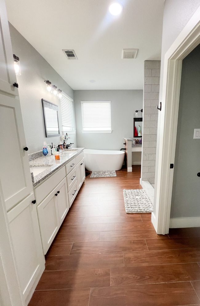 Bathroom featuring vanity, separate shower and tub, and hardwood / wood-style floors | Image 13