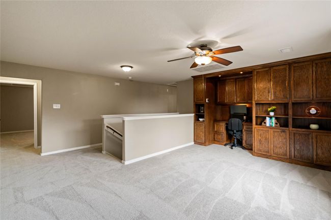 Upstairs gameroom with a Beautiful custom built bookshelf and cabinets with a computer area. | Image 22
