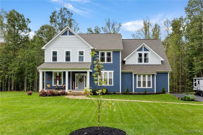 View of front of property with roof with shingles, covered porch, and a front yard | Image 40