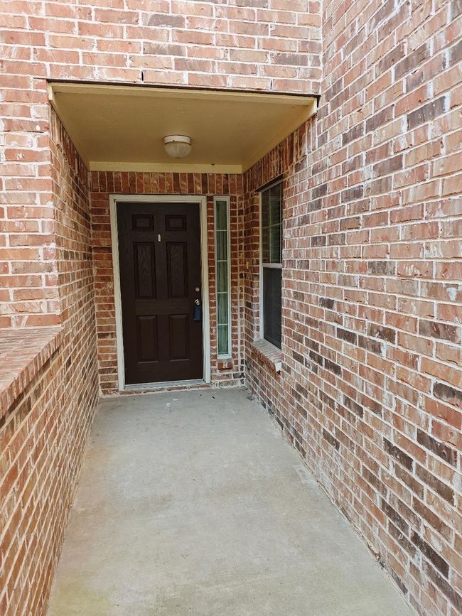 Property entrance with brick siding | Image 6