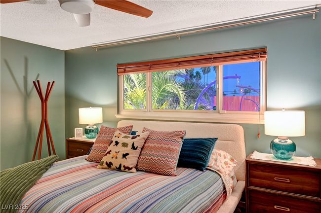 Bedroom featuring a ceiling fan and a textured ceiling | Image 23