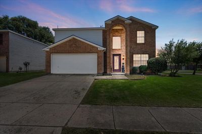 View of front property featuring a yard and a garage | Image 1