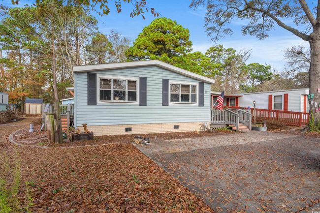 View of front facade with a deck and a storage shed | Image 30