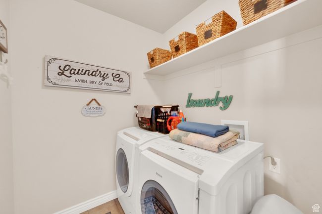 Laundry room featuring washing machine and clothes dryer and baseboards | Image 20