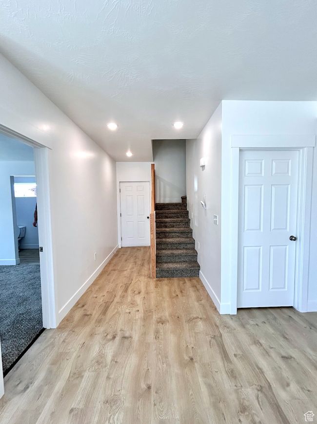 Interior space with baseboards, stairway, and light wood-style floors | Image 17