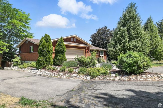 View of front of house with brick siding and a garage | Image 36