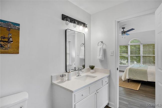 Bathroom with ceiling fan, vanity, toilet, wood finished floors, and ensuite bathroom | Image 13