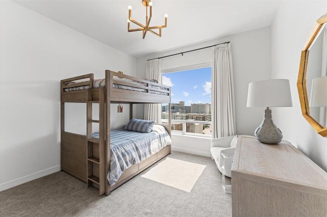 This photo showcases a bright secondary bedroom. | Image 18