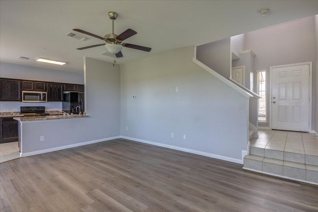 Naturally lit living space. Light, neutral paint throughout. | Image 7