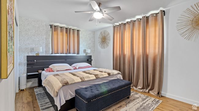 Bedroom with baseboards, a ceiling fan, and wood finished floors | Image 11