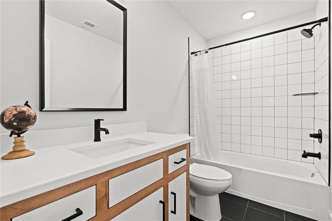 Bathroom with vanity, tile patterned flooring, and shower / tub combo | Image 34