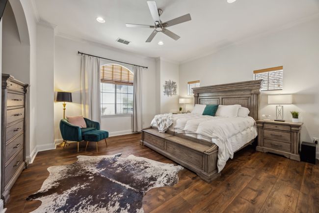 Spacious third-floor primary suite features rich hardwoods, a cozy fireplace, and direct access to an ensuite bath and oversized walk-in closet. | Image 18