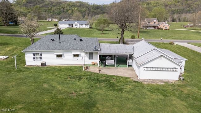 Back of property with roof with shingles, a yard, and central AC unit | Image 6