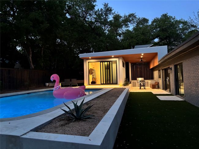 View of swimming pool with an outdoor structure, fence, a fenced in pool, and a patio | Image 37