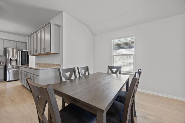 Dining room with light wood-look flooring | Image 12