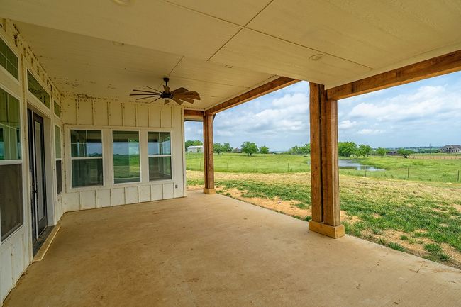 View of patio / terrace featuring a ceiling fan, a water view, and a view of countryside | Image 40