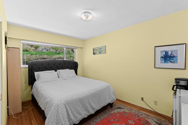 Bedroom with baseboards and wood finished floors | Image 15