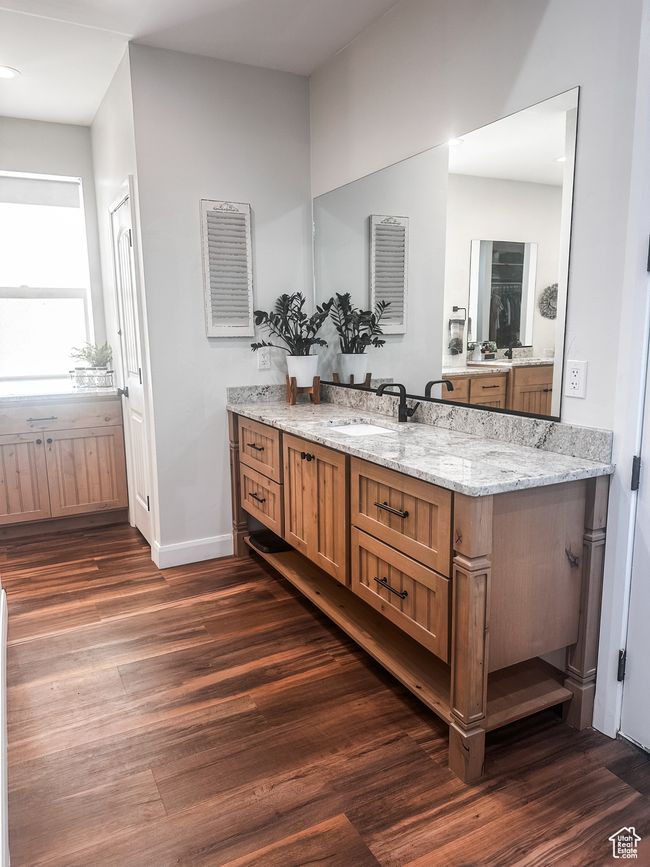 Bathroom featuring baseboards, wood finished floors, and vanity | Image 18